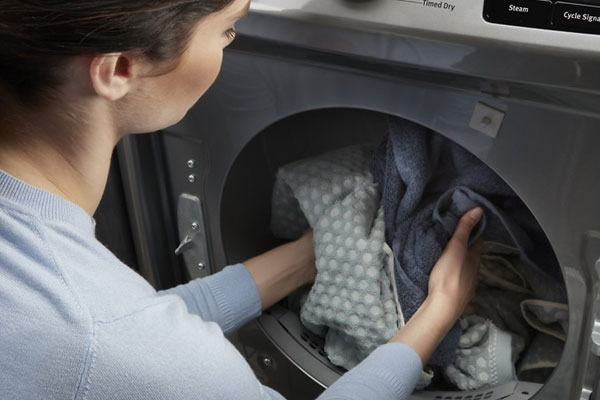 Loading Clothes inside the Washing Machine